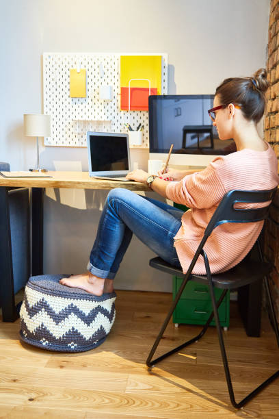 istock Focused woman working at home at table 882236830
