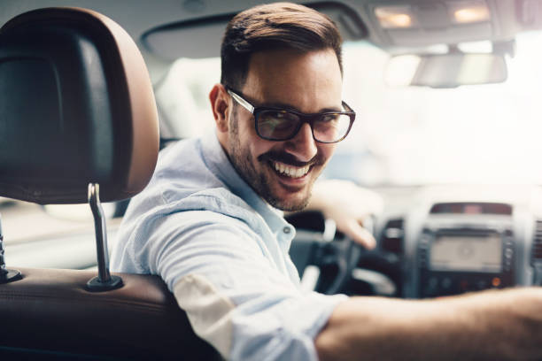 istock Handsome businessman driving a car 882246274