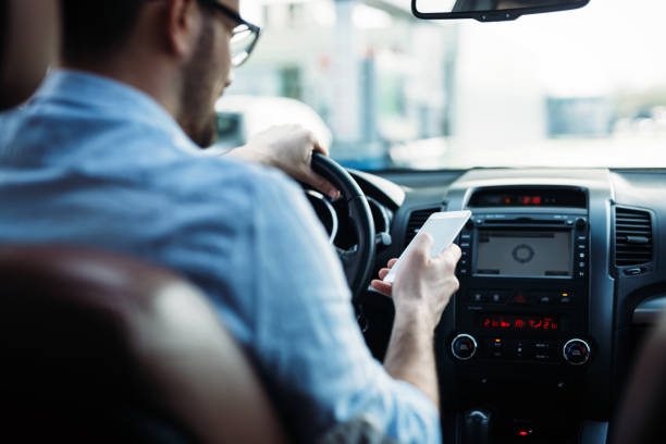 istock Man driver using smart phone on road in car 882246396