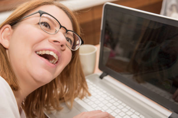 istock Young smiling woman with laptop 882246722