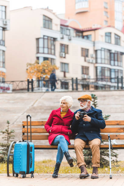 istock tourist couple on bench 882249592