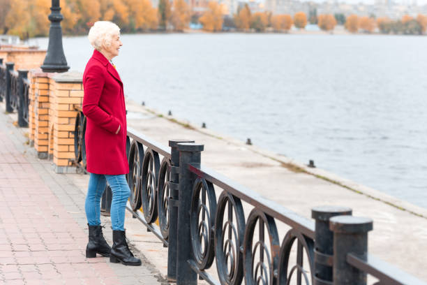 istock woman in red coat on quay 882250438