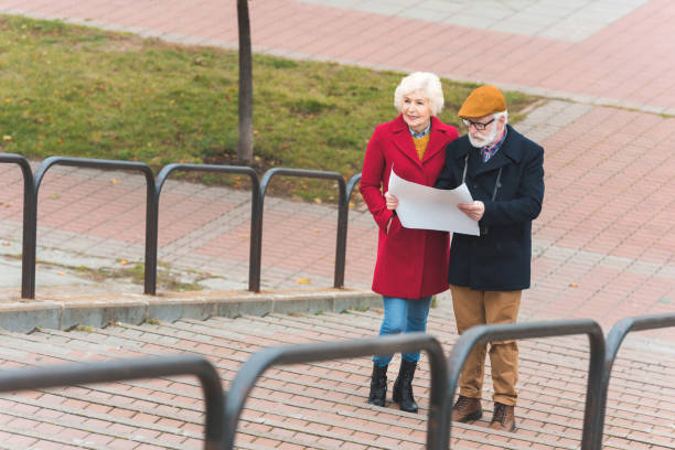 istock senior tourist couple with map 882252046