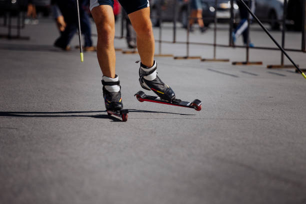 istock feet male athlete in ski-roller rides on asphalt 882254792