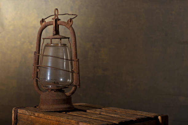 istock Old Rusty Lantern on the Wooden Desk in the Attic 882255940
