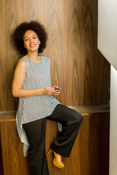 istock Smiling african american businesswoman using mobile phone in office 882256128