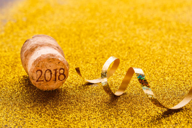 istock Champagne cork and serpentine on glitter backdrop 882259188