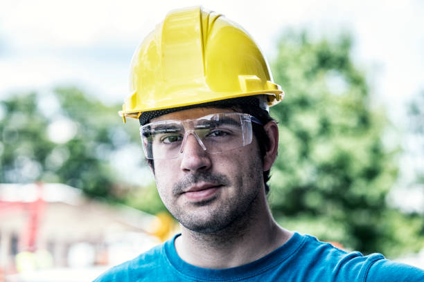 istock Young Man Blue Collar Hardhat Construction Worker Close-Up 882259340