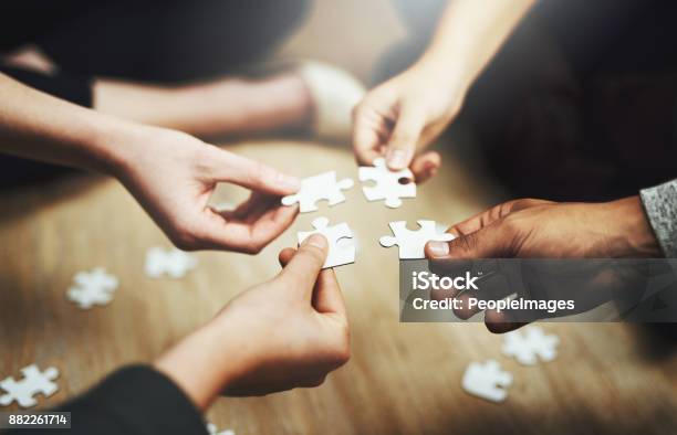 Pulling Together To Solve A Problem Stock Photo - Download Image Now - Teamwork, Togetherness, Jigsaw Piece