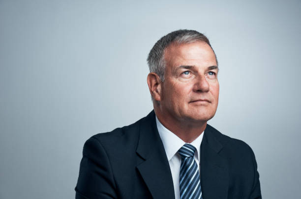 Studio shot of a mature businessman posing against a grey background