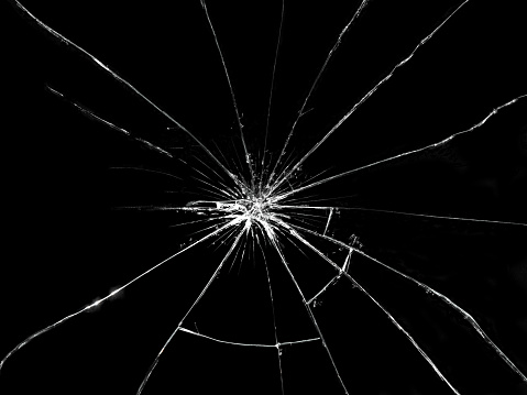 Broken glass on black background. Textured abstract backdrop