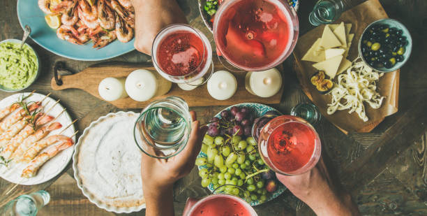 istock Flat-lay of friends hands eating and drinking together, wide composition 882265254