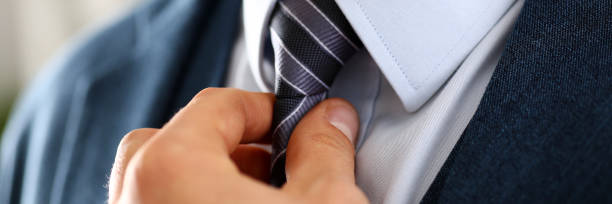 istock Male arm in blue suit set tie closeup 882267514
