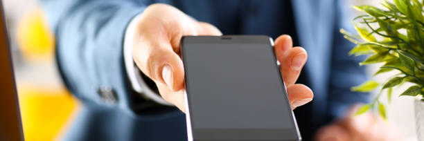 istock Male arm in suit show in camera phone display 882267530