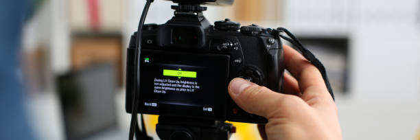 istock Male arms in suit mount camcorder to tripod 882267572