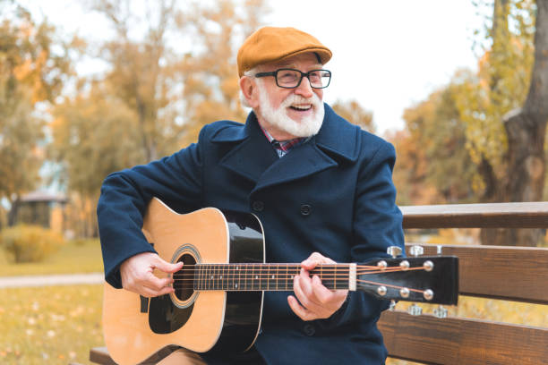 istock senior man playing on guitar 882270412