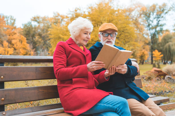 istock couple reading book in park 882272620