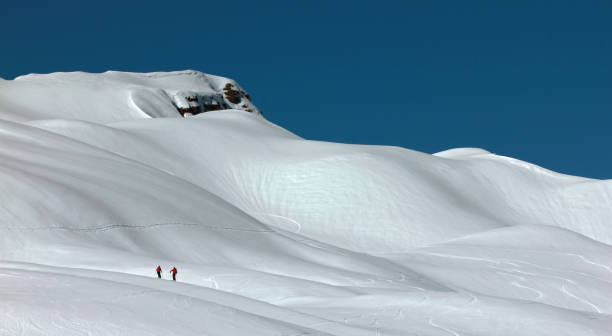 istock Skiers in a heavily snowed-in mountains. 882272718