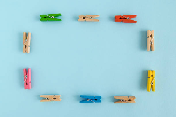 istock Frame from wooden colorful pins on the blue background with copy space. 882272860