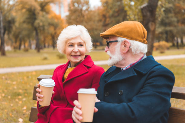 istock senior couple with coffee in park 882273040