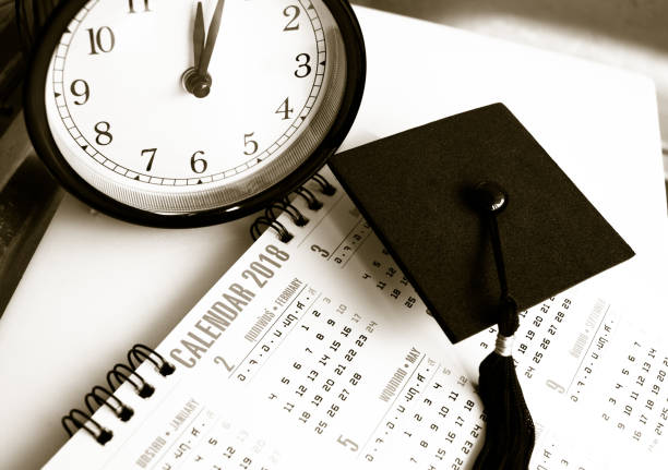 istock Graduation cap on Thai alphabet Calendar 2018 page background with time Clock, Education international Concept, Black and white tone 882273496