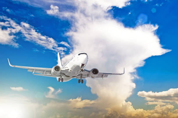 istock Airplane at fly on the sky with cumulus clouds sunset. 882273612