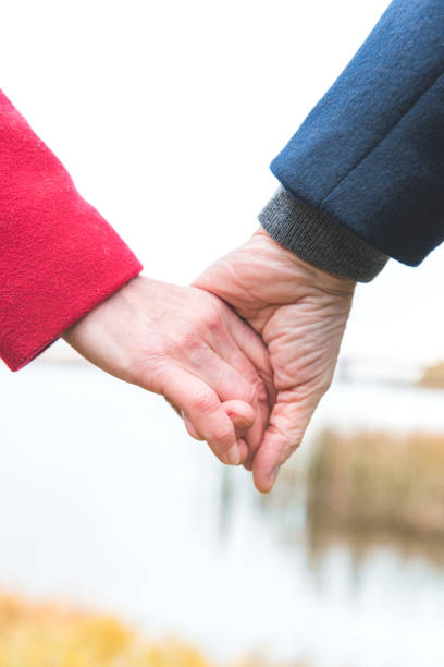 istock senior couple holding hands 882280212