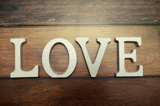 word Love from wooden letters on a wood background