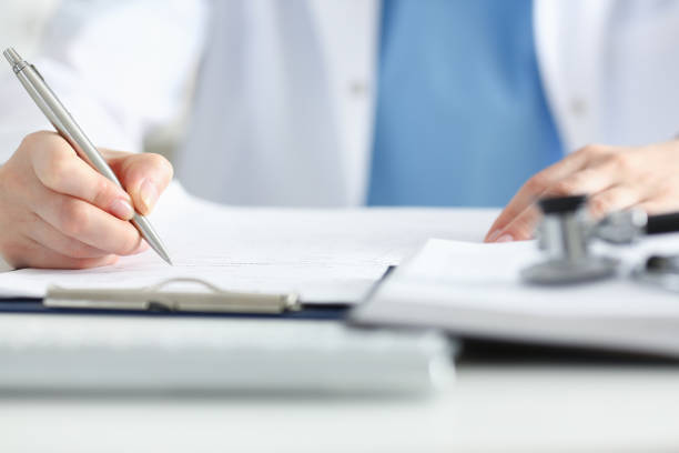 istock Female doctor hand hold silver pen 882281252