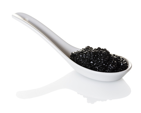 black caviar in spoon on white isolated background