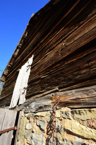 istock Weathered rustic building with rock wall below and wood above 882287884
