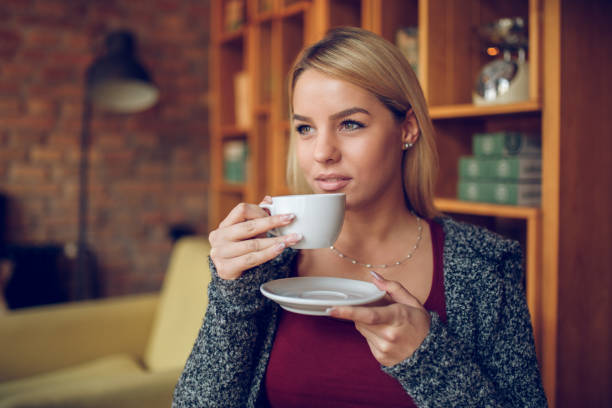 istock Young attractive woman sitting in cafe having coffee break 882288400