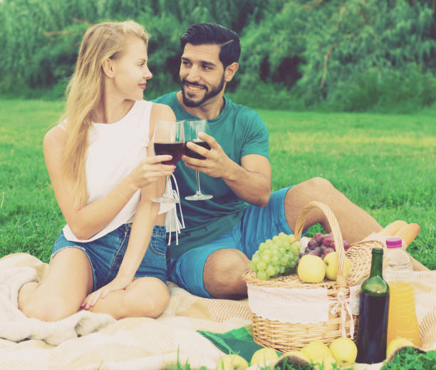 istock Smiling couple is sitting with wineglasses and talking 882291166