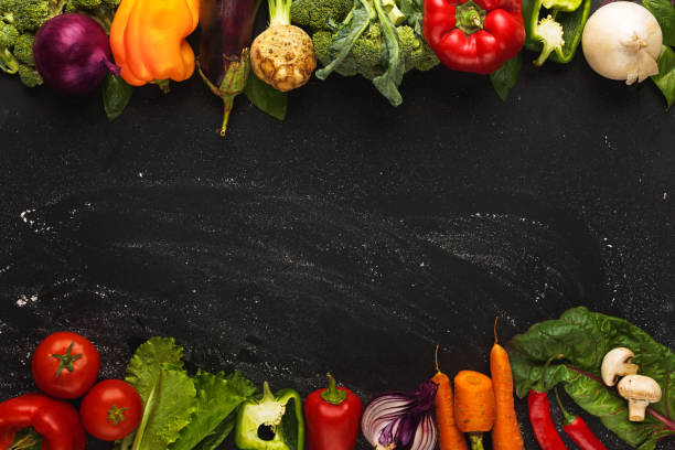 istock Border of fresh vegetables on wooden background with copy space 882291336