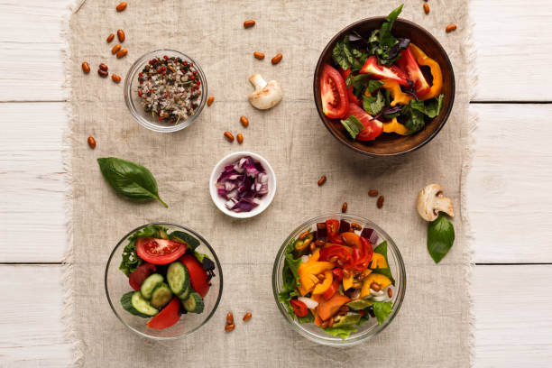 istock Various salad bowls on white wooden table, top view 882291766