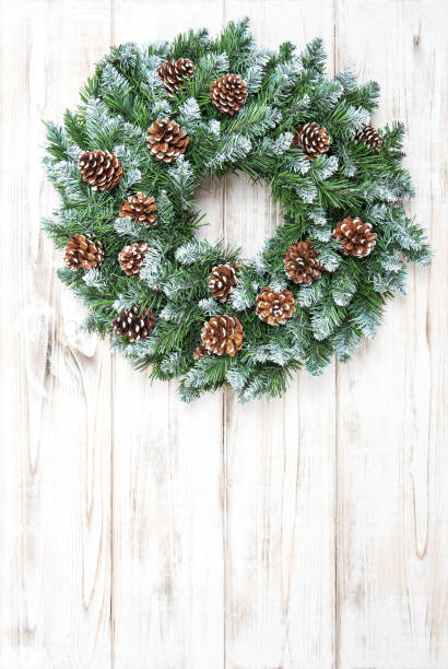 istock Christmas wreath with cones decoration wooden background 882292172