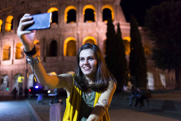 istock Smiling young woman taking selfie in Rome 882295814