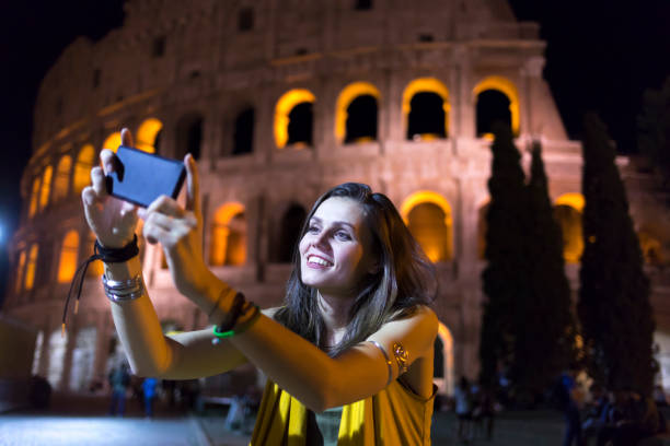 istock Smiling young woman taking selfie in Rome 882295816