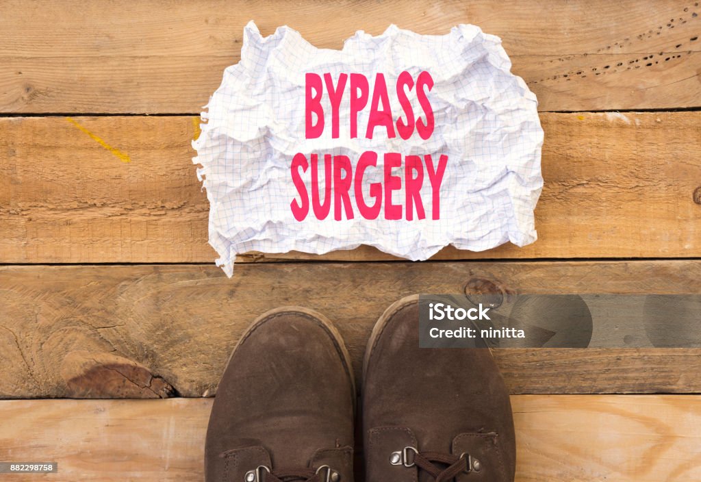 person stand up on wood and need a bypass surgery written in crumpled and crashed paper Algeria Stock Photo