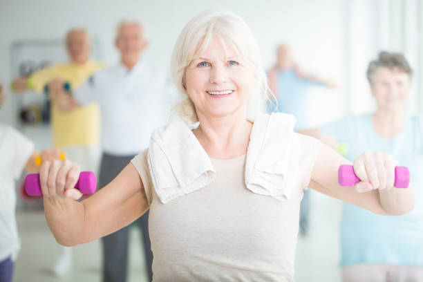 istock Elderly woman exercising with dumbbells 882302258