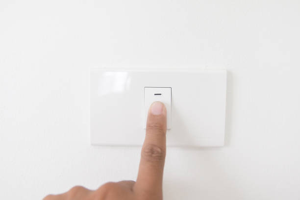 istock Closeup hand turn off a power button,Finger press light button,Hand with Power plug,interior electric power button in home,Concept switch on light 882302634