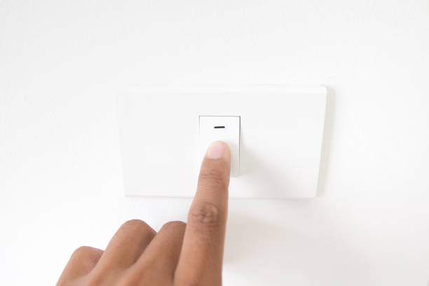 istock Closeup hand turn off a power button,Finger press light button,Hand with Power plug,interior electric power button in home,Concept switch on light 882305914