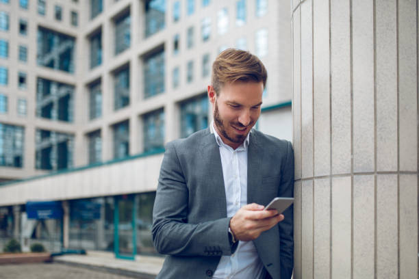 istock Young businessman text massaging outdoors. 882306352