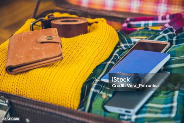 Travel Concepts Luggage With Clothes Passport Wallet Phone Top View Stock Photo - Download Image Now
