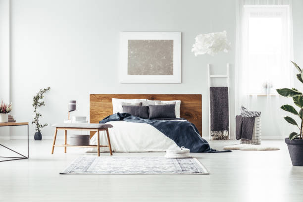 istock Spacious bedroom with silver painting 882311480