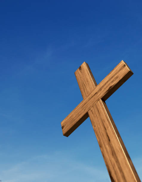 Old, destroyed and neglected roadside Catholic cross. On the cross a figure of Jesus cracked in half.