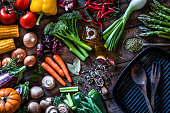 Fresh vegetables ready for cooking shot on rustic wooden table