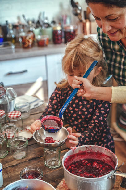 istock Preparing Homemade Raspberry Jam and Canning in Jars 882315534