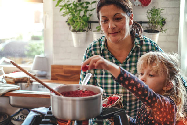 istock Preparing Homemade Raspberry Jam and Canning in Jars 882315566