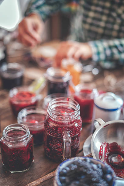 istock Preparing Homemade Strawberry, Blueberry and Raspberry Jam and Canning in Jars 882315568